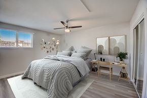 Tempe apartment for rent - A bedroom with a large bed and a ceiling fan.