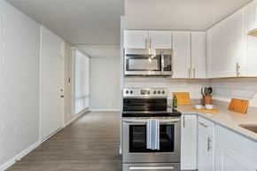 Tempe apartment for rent - A kitchen with a stove top oven and a microwave above it.