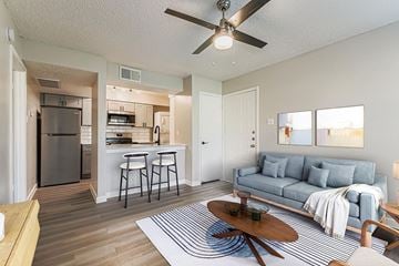 Bedford apartment for rent - A living room with a grey couch and a white coffee table.