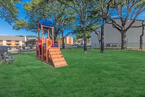 Bedford apartment for rent - A playground with a red slide and a blue roof.