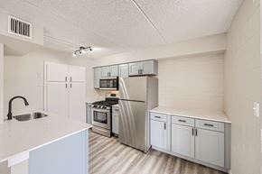 Phoenix apartment for rent - A kitchen with white cabinets and appliances.