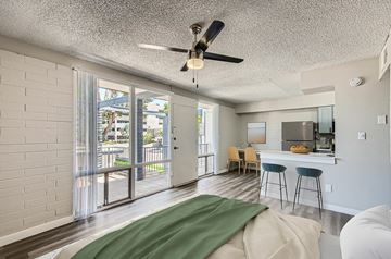 Phoenix apartment for rent - A living room with a green couch and a ceiling fan.