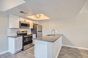 Mesa apartment for rent - A kitchen with white cabinets and a stainless steel refrigerator.