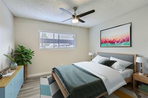 Mesa apartment for rent - A bedroom with a bed, a ceiling fan, and a painting on the wall.