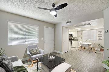 Mesa apartment for rent - A living room with a green chair and a white couch.
