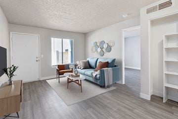 Glendale apartment for rent - A living room with a blue couch and a wooden coffee table.