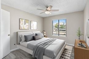Glendale apartment for rent - A bedroom with a large bed and a ceiling fan.