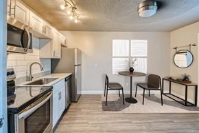 Glendale apartment for rent - A modern kitchen with a dining table set up.
