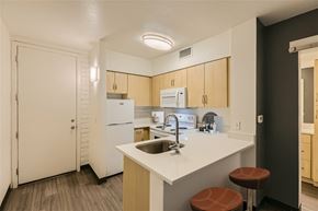 Phoenix apartment for rent - A kitchen with a white counter top and brown stools.