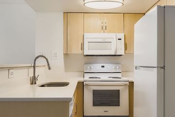 Phoenix apartment for rent - A living room with a grey sofa and a white coffee table.