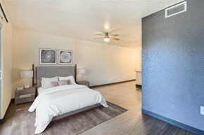 Phoenix apartment for rent - A bedroom with a large bed and a ceiling fan.