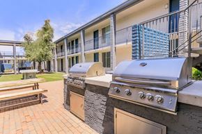 Phoenix apartment for rent - A BBQ grill is in front of a building with a balcony.