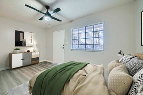 Phoenix apartment for rent - A bedroom with a bed covered in a green blanket.