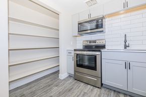 Phoenix apartment for rent - A modern kitchen with a stainless steel oven and microwave above it.