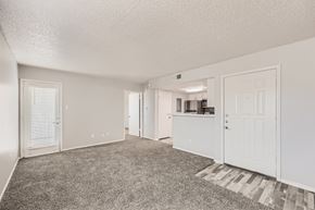 Arlington apartment for rent - A spacious room with white walls and carpeted floor.