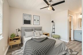 Arlington apartment for rent - A bedroom with a bed, a ceiling fan, and two pictures on the wall.