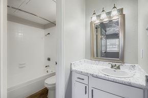 Arlington apartment for rent - A swimming pool surrounded by a fence and a building in the background.