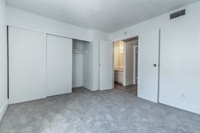 Phoenix apartment for rent - A sparsely furnished room with a carpeted floor and white walls.