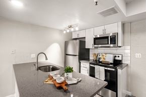 Phoenix apartment for rent - A kitchen with a grey counter top and stainless steel appliances.
