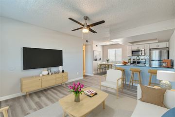 Phoenix apartment for rent - A living room with a wooden coffee table and a flat screen TV mounted on the wall.