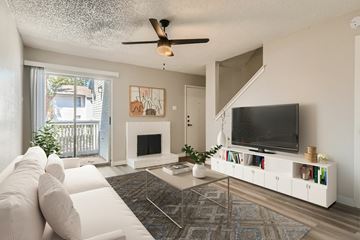 Arlington apartment for rent - A living room with a white couch and a television.