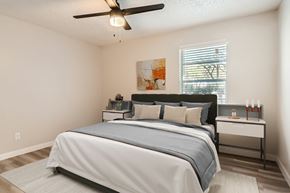 Arlington apartment for rent - A bedroom with a large bed and a ceiling fan.
