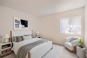Phoenix apartment for rent - A bedroom with a large bed and a chair.