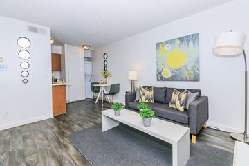 Glendale apartment for rent - A living room with a grey couch, a white coffee table, and a painting on the wall.