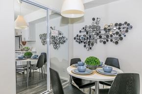 Glendale apartment for rent - A dining room with a white table and black chairs.