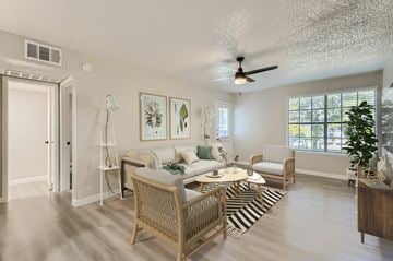 Bedford apartment for rent - A living room with a sofa set, a coffee table, and a ceiling fan.