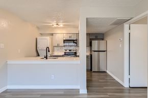 Bedford apartment for rent - A kitchen with white cabinets and a white island.