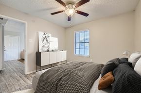 Bedford apartment for rent - A bedroom with a large bed and a ceiling fan.
