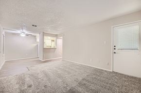 Bedford apartment for rent - A sparsely furnished room with a carpeted floor and a ceiling fan.