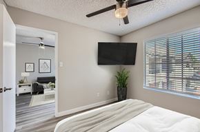 Phoenix apartment for rent - A bedroom with a large bed and a flat screen TV mounted on the wall.