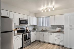 Phoenix apartment for rent - A kitchen with white cabinets and appliances.