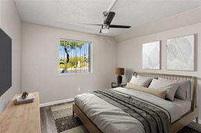 Phoenix apartment for rent - A bedroom with a bed, nightstand, and window.