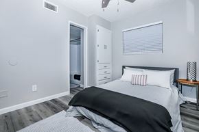 Mesa apartment for rent - A kitchen with white cabinets and a wooden table.