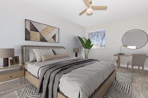 Phoenix apartment for rent - A bedroom with a large bed and a ceiling fan.