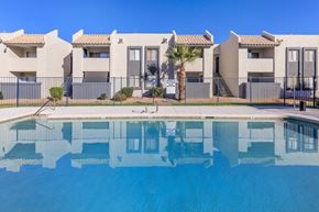 Phoenix apartment for rent - A row of houses with a pool in front.