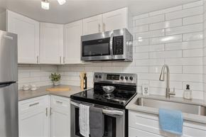 Glendale apartment for rent - A kitchen with white cabinets and a black stove top.