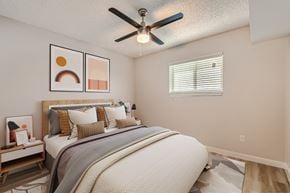 Glendale apartment for rent - A bedroom with a large bed and a ceiling fan.