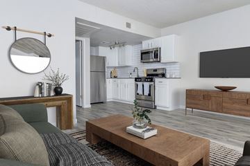 Glendale apartment for rent - A modern living room with a grey sofa and a wooden coffee table.