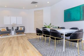 Glendale apartment for rent - A dining room with a white table and black chairs.