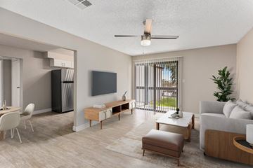 Phoenix apartment for rent - A modern living room with a flat screen TV, a white sofa, and a dining table with chairs.