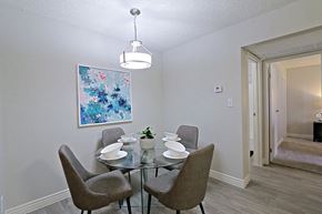 Phoenix apartment for rent - A dining room with a glass table and grey chairs.