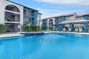 Phoenix apartment for rent - A large swimming pool in front of apartment buildings.