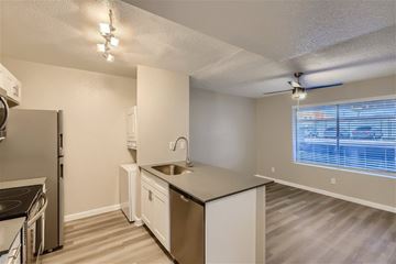 Glendale apartment for rent - A kitchen with white cabinets and a black countertop.