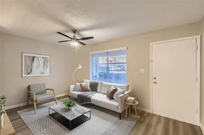 Glendale apartment for rent - A living room with a couch, chair, and a plant on the coffee table.