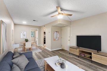 Phoenix apartment for rent - A living room with a grey couch and a black television.