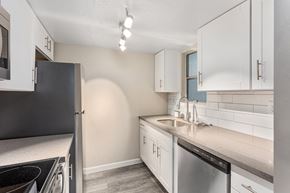 Phoenix apartment for rent - A kitchen with white cabinets and a black refrigerator.
